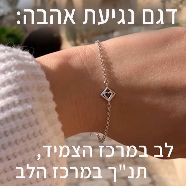 אישה עונדת צמיד לב במעין עם ננו תנ"ך מבית ננו תכשיטים- יום האהבה טו באב